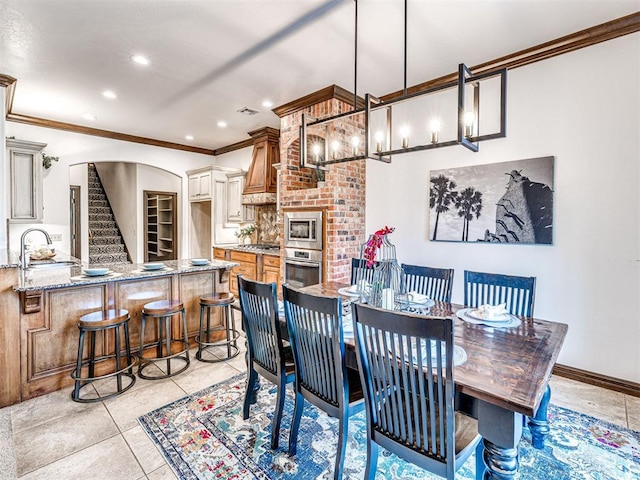 dining space with crown molding, stairway, arched walkways, recessed lighting, and light tile patterned flooring