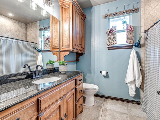 full bath with baseboards, vanity, toilet, a shower with shower curtain, and tile patterned floors