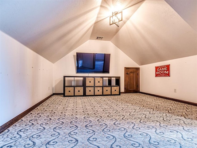 bonus room featuring lofted ceiling, carpet floors, and baseboards