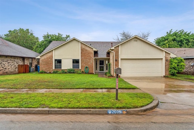 view of front of property with a garage, concrete driveway, brick siding, and a front lawn