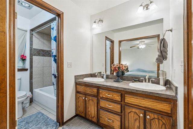 full bathroom with double vanity, ceiling fan, toilet, shower / tub combo with curtain, and tile patterned flooring