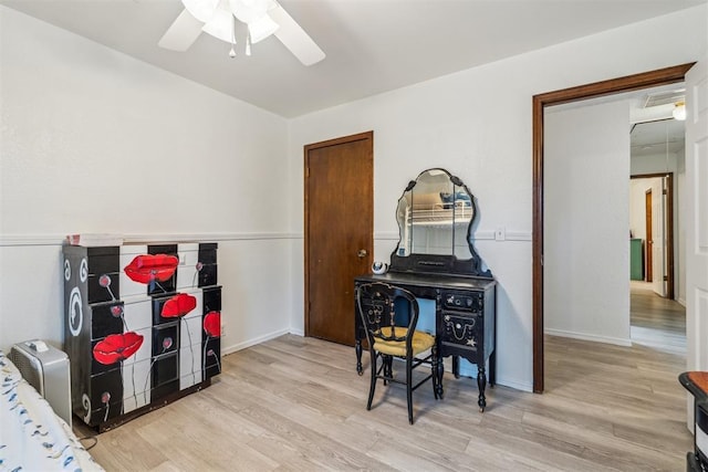 bedroom featuring wood finished floors, a ceiling fan, and baseboards