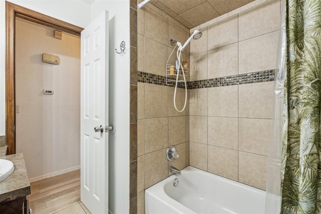 full bath with shower / bath combination with curtain, wood finished floors, and baseboards