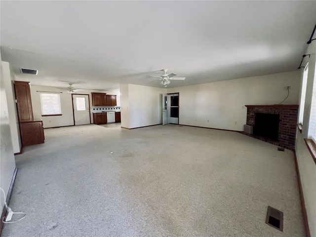 36040 E 1140th Rd Unit 114Rd, Seminole, OK 74868 - unfurnished living room with a ceiling fan, a brick fireplace, and baseboards