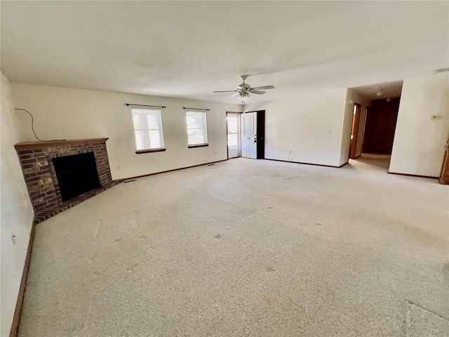 36040 E 1140th Rd Unit 114Rd, Seminole, OK 74868 - unfurnished living room featuring a brick fireplace, baseboards, a ceiling fan, and light colored carpet