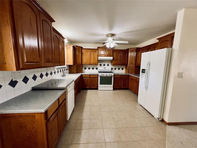 36040 E 1140th Rd Unit 114Rd, Seminole, OK 74868 - kitchen with white appliances, under cabinet range hood, backsplash, a ceiling fan, and brown cabinets