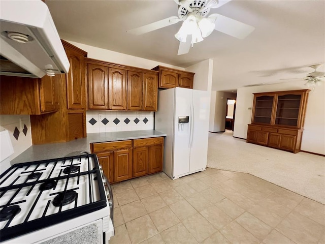 36040 E 1140th Rd Unit 114Rd, Seminole, OK 74868 - kitchen with white appliances, range hood, a ceiling fan, brown cabinets, and backsplash