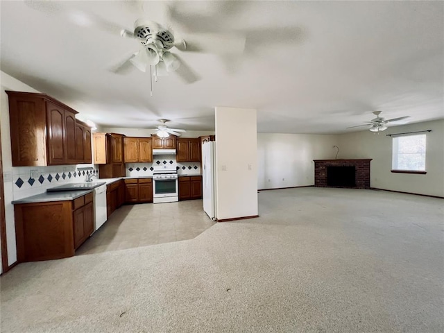 36040 E 1140th Rd Unit 114Rd, Seminole, OK 74868 - kitchen with white appliances, a ceiling fan, decorative backsplash, and light carpet