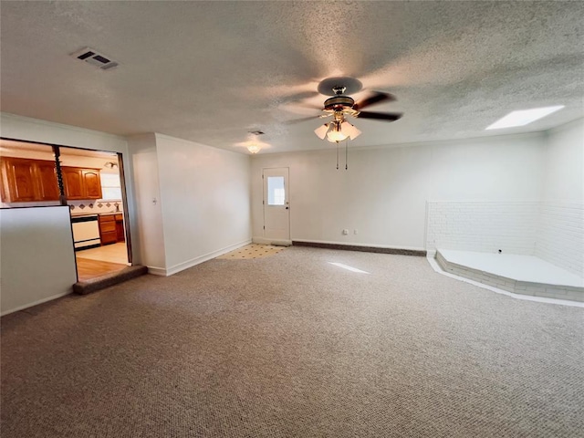 36040 E 1140th Rd Unit 114Rd, Seminole, OK 74868 - empty room with ceiling fan, a textured ceiling, light carpet, and baseboards