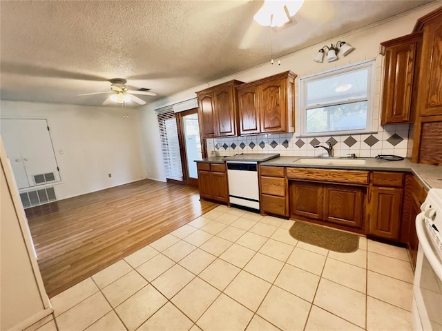 36040 E 1140th Rd Unit 114Rd, Seminole, OK 74868 - kitchen featuring white appliances, a sink, ceiling fan, decorative backsplash, and a textured ceiling
