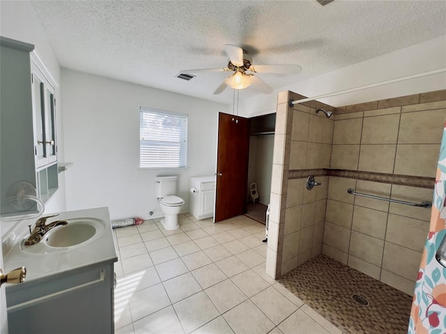 36040 E 1140th Rd Unit 114Rd, Seminole, OK 74868 - full bathroom with a ceiling fan, vanity, tiled shower, tile patterned flooring, and a textured ceiling