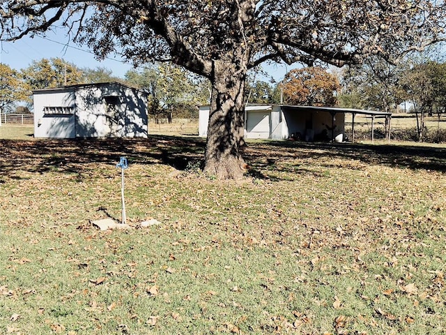 36040 E 1140th Rd Unit 114Rd, Seminole, OK 74868 - view of yard featuring a carport and an outdoor structure