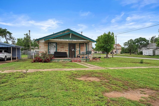 view of front facade featuring covered porch, a carport, and stone siding