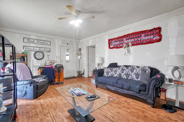 living area with a ceiling fan and wood finished floors