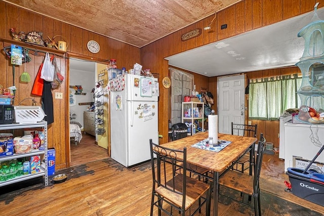 dining area featuring wood walls, hardwood / wood-style flooring, and wooden ceiling