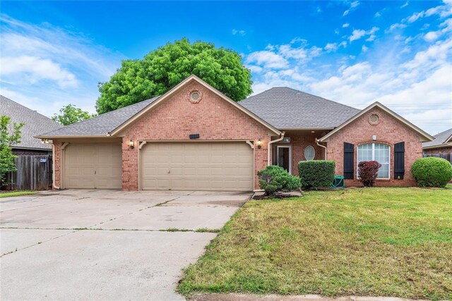 2617 Tracys Ter, Edmond, OK 73013 - view of front of property featuring brick siding, an attached garage, concrete driveway, and roof with shingles