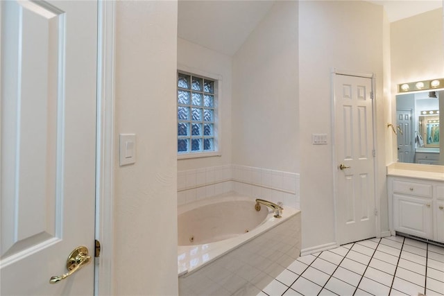 2617 Tracys Ter, Edmond, OK 73013 - bathroom with vanity, a jetted tub, lofted ceiling, tile patterned floors, and baseboards