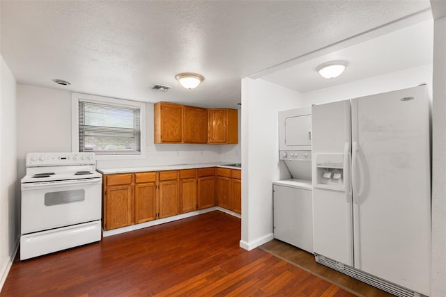 5102 N Beaver Ave, Bethany, OK 73008 - kitchen with white appliances, stacked washer / dryer, dark wood-type flooring, light countertops, and brown cabinets