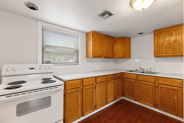 5102 N Beaver Ave, Bethany, OK 73008 - kitchen with white electric range oven, a sink, dark wood-style floors, light countertops, and brown cabinetry