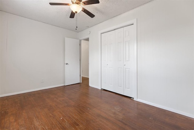 5102 N Beaver Ave, Bethany, OK 73008 - unfurnished bedroom with hardwood / wood-style flooring, baseboards, a closet, a ceiling fan, and a textured ceiling