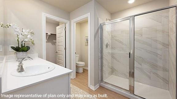 10509 SW 23rd St, Yukon, OK 73099 - full bathroom with a stall shower, toilet, wood finished floors, and vanity