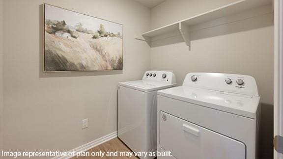 10509 SW 23rd St, Yukon, OK 73099 - laundry area featuring washer and dryer, wood finished floors, and baseboards