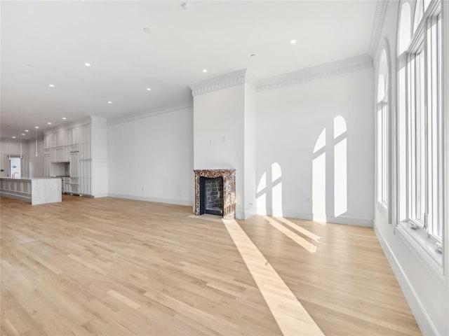 6100 NW Grand Blvd Unit 6103, Oklahoma City, OK 73118 - unfurnished living room with crown molding, light wood-type flooring, a fireplace with flush hearth, baseboards, and recessed lighting