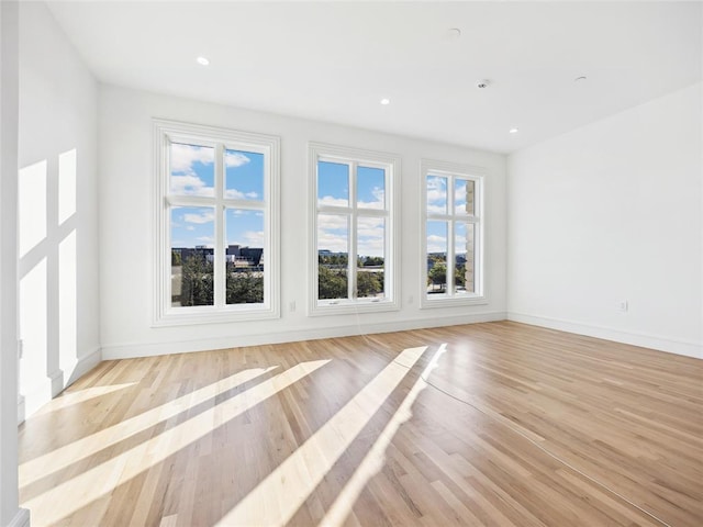 6100 NW Grand Blvd Unit 6103, Oklahoma City, OK 73118 - unfurnished living room with light wood-type flooring, baseboards, and recessed lighting