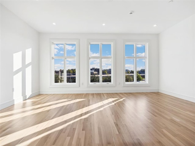 6100 NW Grand Blvd Unit 6103, Oklahoma City, OK 73118 - unfurnished living room featuring wood finished floors, baseboards, and recessed lighting
