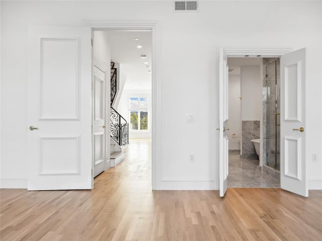 6100 NW Grand Blvd Unit 6103, Oklahoma City, OK 73118 - hall featuring stairs, light wood finished floors, and baseboards