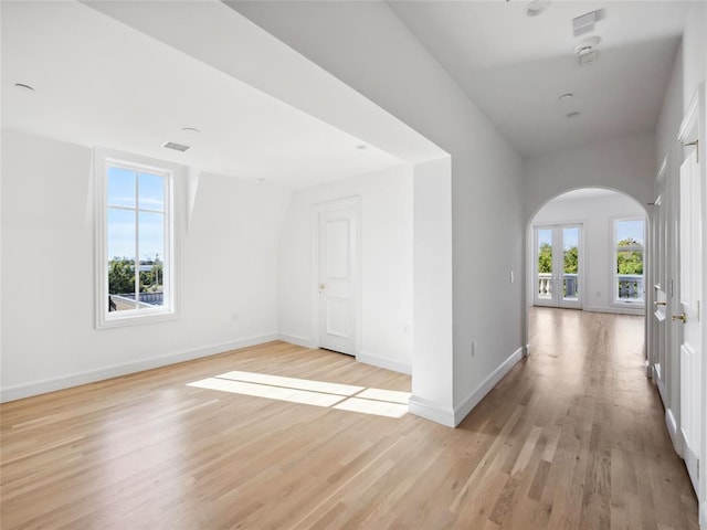 6100 NW Grand Blvd Unit 6103, Oklahoma City, OK 73118 - additional living space with arched walkways, light wood-style floors, and baseboards