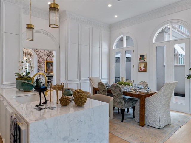 6119 NW Grand Blvd, Oklahoma City, OK 73118 - dining room featuring a decorative wall, light wood-style floors, recessed lighting, a chandelier, and crown molding
