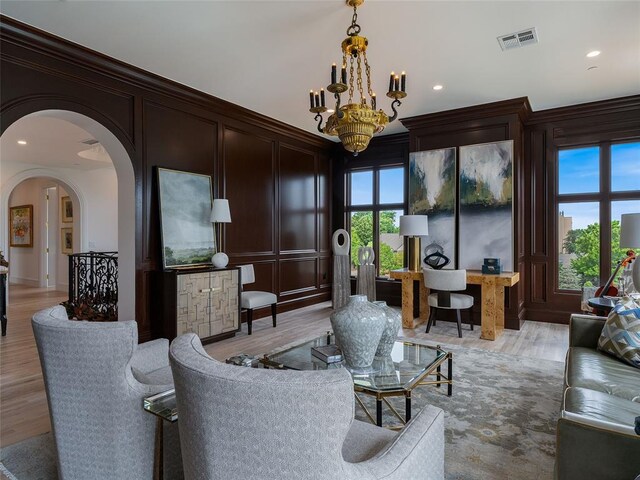 6119 NW Grand Blvd, Oklahoma City, OK 73118 - living room with a decorative wall, a chandelier, arched walkways, light wood-type flooring, and recessed lighting