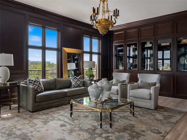6119 NW Grand Blvd, Oklahoma City, OK 73118 - living area featuring a chandelier, a decorative wall, wood finished floors, and ornamental molding