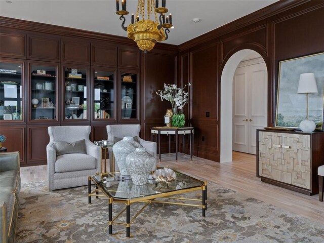 6119 NW Grand Blvd, Oklahoma City, OK 73118 - living room with a decorative wall, a chandelier, arched walkways, and light wood-type flooring