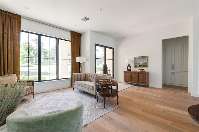 living area with light wood finished floors and baseboards