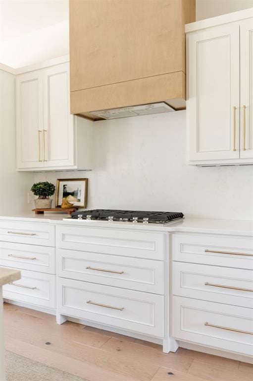 kitchen with gas stovetop, light countertops, and white cabinetry