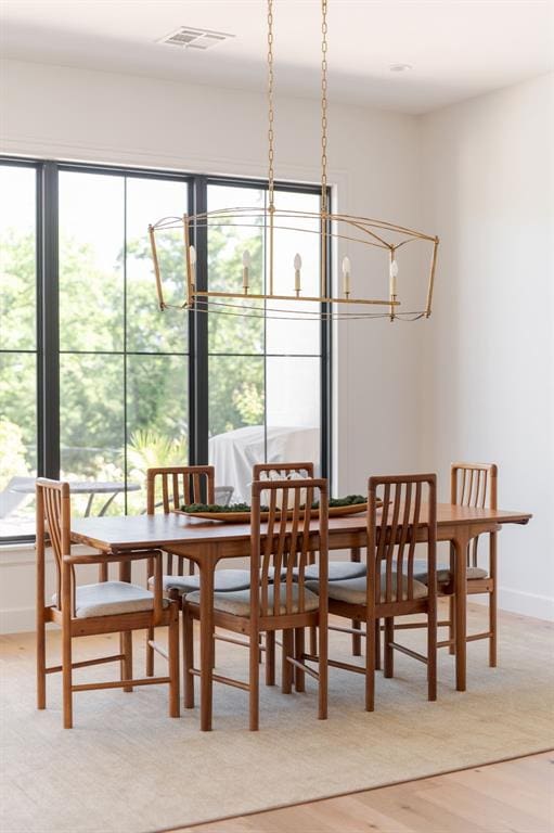 dining room featuring light wood finished floors and baseboards
