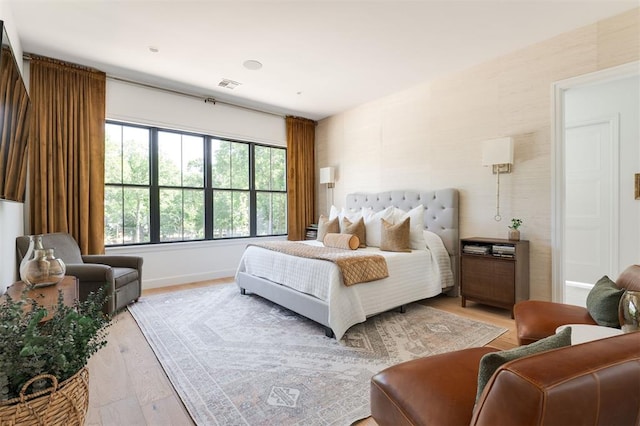 bedroom featuring light wood-type flooring and baseboards