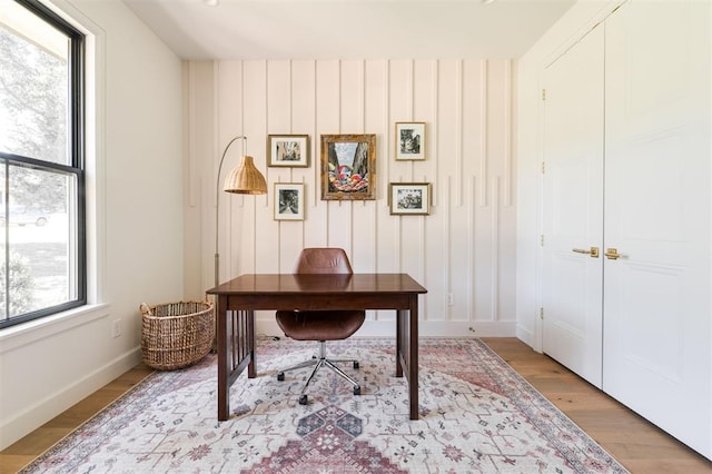 office space with light wood-style floors and baseboards