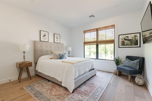 bedroom with baseboards and light wood-type flooring