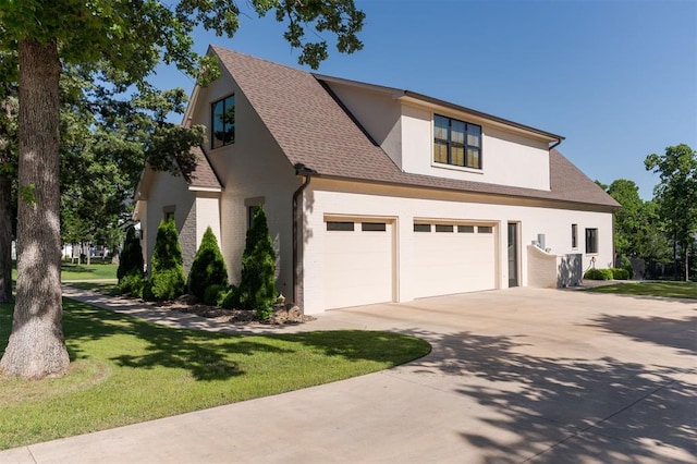 view of front of home with concrete driveway, a shingled roof, a front lawn, stucco siding, and brick siding