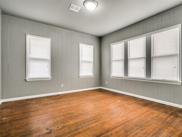 empty room featuring hardwood / wood-style floors and baseboards