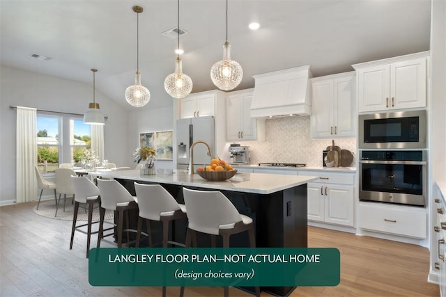 kitchen featuring oven, custom exhaust hood, built in microwave, vaulted ceiling, and tasteful backsplash
