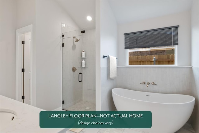 bathroom with a stall shower, lofted ceiling, and a soaking tub