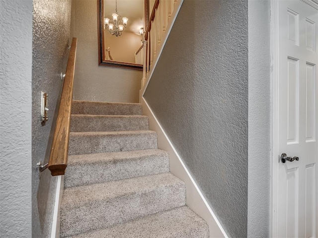 1409 Echohollow Trl, Edmond, OK 73025 - stairway with a textured wall and a chandelier