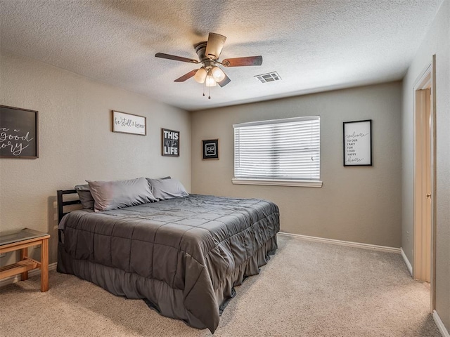 1409 Echohollow Trl, Edmond, OK 73025 - carpeted bedroom with a textured ceiling, ceiling fan, and baseboards