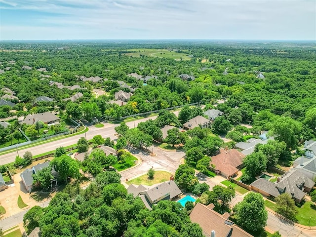 1409 Echohollow Trl, Edmond, OK 73025 - aerial perspective of suburban area with a forest