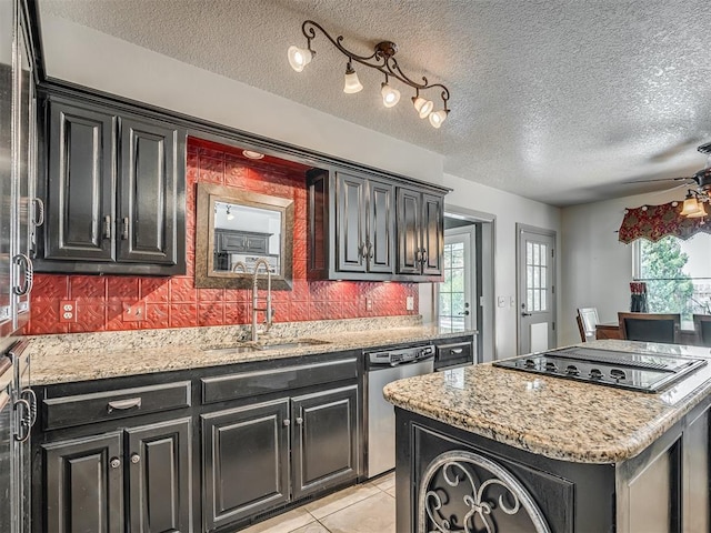 1409 Echohollow Trl, Edmond, OK 73025 - kitchen featuring stainless steel dishwasher, dark cabinetry, a center island, decorative backsplash, and healthy amount of natural light