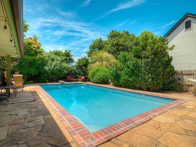 1409 Echohollow Trl, Edmond, OK 73025 - view of swimming pool featuring a patio, a fenced backyard, and a diving board